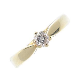A 14ct gold diamond single-stone ring. The brilliant-cut diamond, to the tapered shoulders and plain