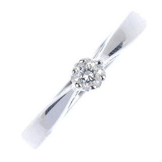 * An 18ct gold diamond single-stone ring. The brilliant-cut diamond, to the tapered shoulders and pl