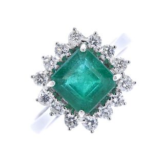 * An 18ct gold emerald and diamond cluster ring. The square-shape emerald, within a brilliant-cut di