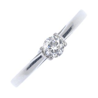 An 18ct gold diamond single-stone ring. The brilliant-cut diamond, within an openwork mount, to the
