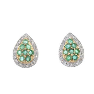 A pair of 9ct gold emerald and diamond cluster ear studs. Each designed as a circular-shape emerald