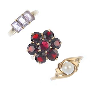 A selection of three 9ct gold gem-set rings. To include a garnet cluster ring, an amethyst three-sto