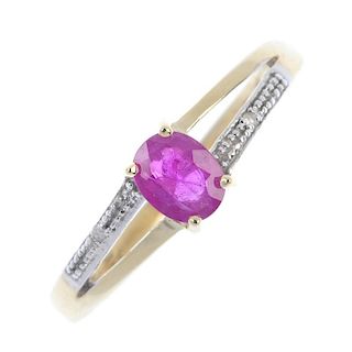A 9ct gold ruby and diamond ring. The oval-shape ruby, to the bifurcated shoulders and single-cut di