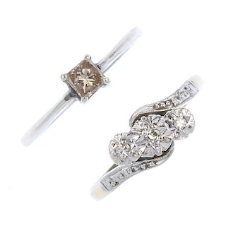 Two diamond rings. To include a mid 20th century 18ct gold and platinum diamond three-stone crossove