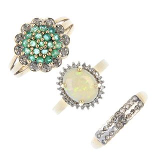 A selection of three diamond and gem-set rings. To include a 9ct gold emerald and diamond cluster ri