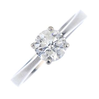 * An 18ct gold diamond single-stone ring. The brilliant-cut diamond, to the tapered shoulders and pl