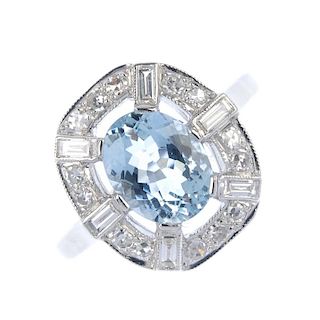 An aquamarine and diamond dress ring. The oval-shape aquamarine, within a single and baguette-cut di
