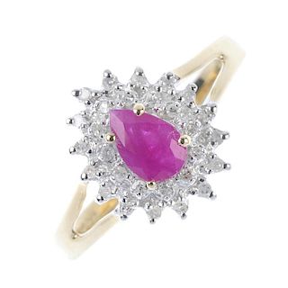 A 9ct gold ruby and diamond cluster ring. The pear-shape ruby, within a single-cut diamond double bo