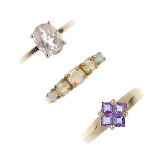 A selection of four gem-set dress rings. To include an opal five-stone ring, a 9ct gold opal and gar