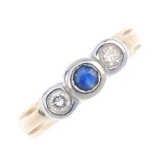 A sapphire and diamond three-stone ring. Of bi-colour design, the circular-shape sapphire collet, wi