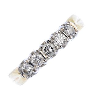 An 18ct gold diamond five-stone ring. The brilliant-cut diamond line, with bar spacers, to the groov