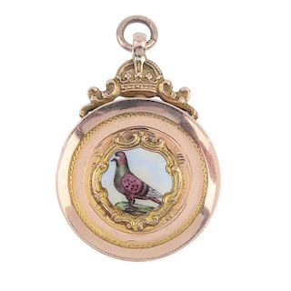 A 1930s 9ct gold enamel pigeon medallion. The enamel pigeon, within a circular-shape surround, to th