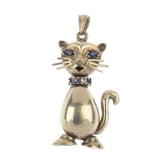 A 9ct gold gem-set novelty pendant. Designed as a cat, with synthetic sapphire eyes and vari-gem col