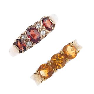 A selection of four 9ct gold gem-set rings. To include a garnet and diamond dress ring, an emerald a