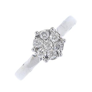 A diamond cluster ring. The brilliant-cut diamond, within a single-cut diamond surround. Total diamo