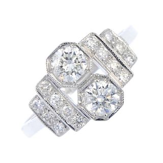 A diamond dress ring. Of geometric design, the two brilliant-cut diamonds, to the similarly-cut diam