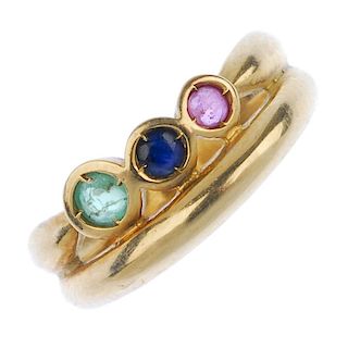 A multi-gem dress ring. The circular-shape graduated emerald, sapphire and ruby collet line, with ta