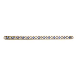 An early 20th century 15ct gold sapphire and split pearl bar brooch. Of openwork design the alternat