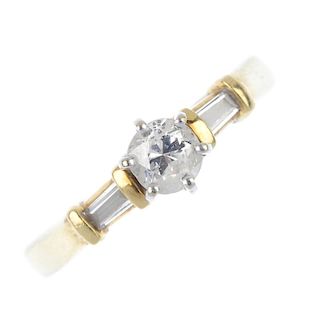 An 18ct gold diamond single-stone ring. The brilliant-cut diamond, raised to the tapered baguette-cu