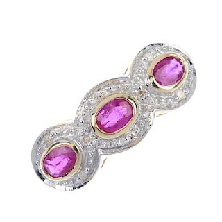 A 9ct gold ruby and diamond triple cluster ring. The three oval-shape ruby collets, each within a si