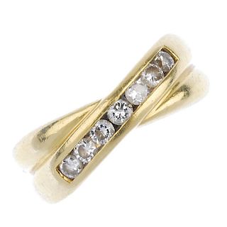 An 18ct gold diamond dress ring. The brilliant-cut diamond line, inset to the crossover bands. Estim