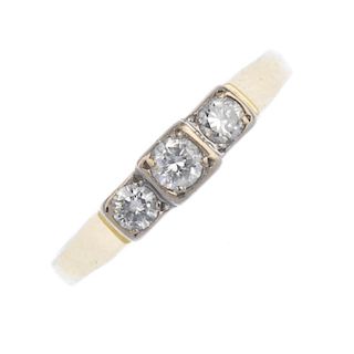 An 18ct gold diamond three-stone ring. The brilliant-cut diamond stepped line, to the tapered should