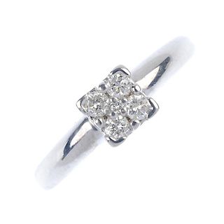 A diamond ring. The brilliant-cut diamond, within a similarly-cut diamond quatrefoil, to the tapered