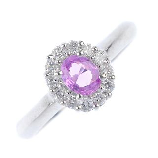* A 9ct gold sapphire and diamond cluster ring. The oval-shape pink sapphire, within a brilliant-cut