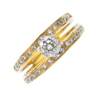 A diamond dress ring. The brilliant-cut diamond, to the similarly-cut diamond line sides and double