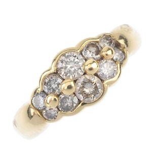 An 18ct gold diamond ring. Comprising two graduated brilliant-cut diamond scalloped lines, to the ta