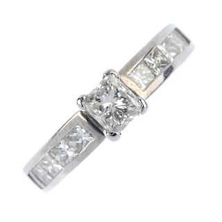 A diamond single-stone ring. The square-shape diamond, to the similarly-cut diamond shoulders and pl