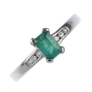 An 18ct gold emerald and diamond dress ring. The rectangular-shape emerald, to the single-cut diamon