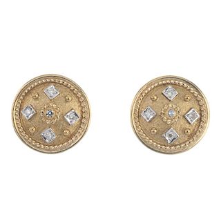 A pair of 9ct gold diamond earrings. Each designed as a circular-shape textured panel, with single-c