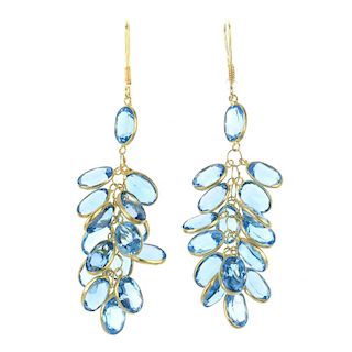 A pair of topaz ear pendants. Each designed as an oval-shape blue topaz collet elongated cluster, su