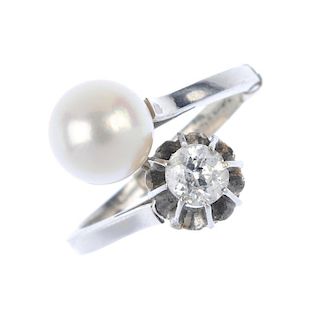 A diamond and cultured pearl crossover ring. Designed as an asymmetric band, with cultured pearl and