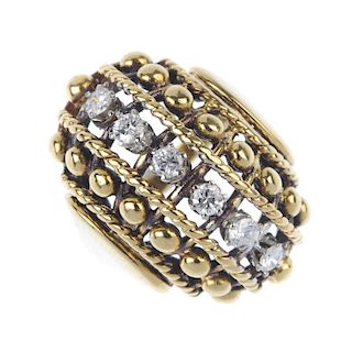 An 18ct gold diamond dress ring. The brilliant-cut diamond line, with alternating rope-twist and bea