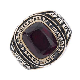 A synthetic ruby college ring. The cushion-shape synthetic ruby, with script surround and symbol sho