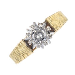 An 18ct gold diamond single-stone ring. The brilliant-cut diamond, to the textured shoulders and tap