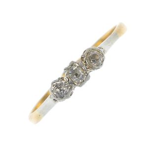 A mid 20th century 18ct gold and platinum diamond three-stone ring. The slightly graduated old-cut d