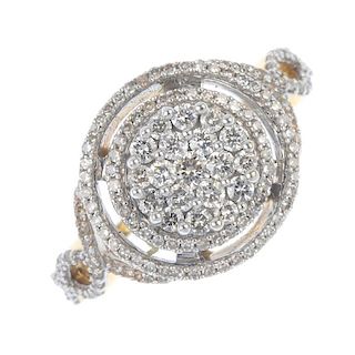 A diamond cluster ring. The pave-set diamond disc, with single-cut diamond double halo and interwove