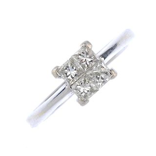 An 18ct gold diamond cluster ring. The square-shape diamond panel, to the tapered shoulders and plai