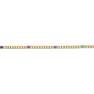 A ruby, emerald and sapphire bracelet. Designed as a series of oval ruby, emerald and sapphire caboc