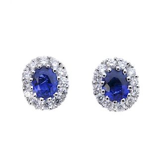 * A pair of sapphire and diamond cluster earrings. Each designed as an oval-shape sapphire, within a