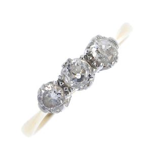 A mid 20th century 18ct gold diamond three-stone ring. The old and brilliant-cut diamond line, to th