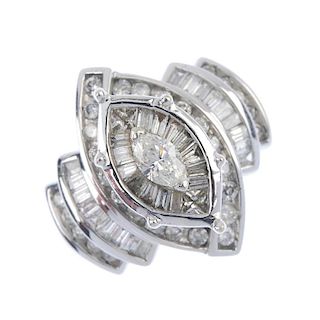 A diamond dress ring. The marquise-shape diamond, within a tapered baguette-cut and square-shape dia