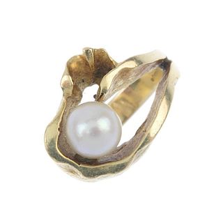 A 1970s 14ct gold cultured pearl dress ring. The cultured pearl, measuring 8.2mms, to the textured,