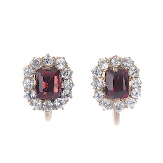 A pair of garnet and paste cluster ear clips. The rectangular-shape garnet, within a circular-shape
