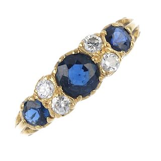 A mid 20th century 18ct gold sapphire and diamond ring. The graduated circular-shape sapphire line,