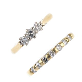 Two 18ct gold diamond dress rings. To include a brilliant-cut diamond three-stone ring and a brillia