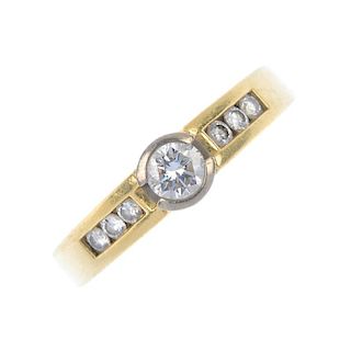 A diamond ring. The brilliant-cut diamond collet, with similarly-cut diamond line sides, inset to th